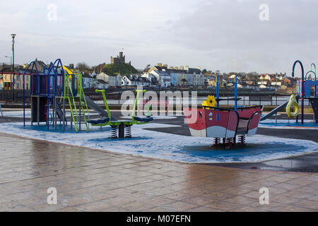 The colourful children's playground on the seafront in Donaghadee county Down in Northern Ireland in a freezing winter afternoon Stock Photo