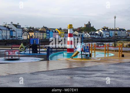 The colourful children's playground on the seafront in Donaghadee county Down in Northern Ireland in a freezing winter afternoon Stock Photo