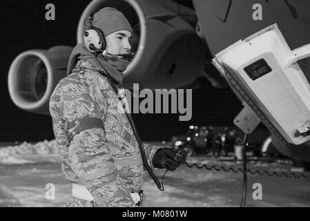 Senior Airman Garrett Battle, 736th Aircraft Maintenance Squadron communication and navigation journeyman, stands near the nose of a C-17A Globemaster III as the aircraft is being refueled, Jan. 5, 2018, at Dover Air Force Base, Del. Battle and other 736th AMXS maintainers prepared the aircraft for a mission in temperatures in the low teens and blowing snow from a steady 15 mile per hour wind. (U.S. Air Force Stock Photo