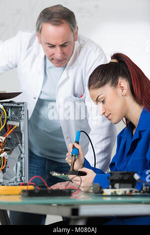 melting solder wire on soldering iron tip Stock Photo