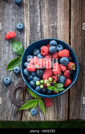 Fresh blueberries and raspberries on old wooden rustic table Stock Photo