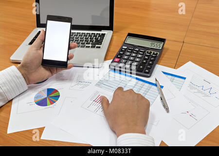 Businessman using smart phone on his plane project Stock Photo