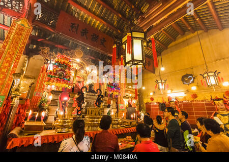 China, Hong Kong, Central, Hollywood Road, Man Mo Temple, Worshippers Praying Stock Photo