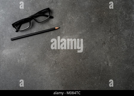 Office desktop with pencil and glasses. Top view Stock Photo
