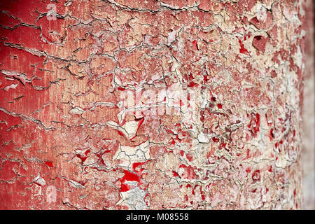 Cracking and peeling paint on a wall, background or texture, selective focus. Stock Photo