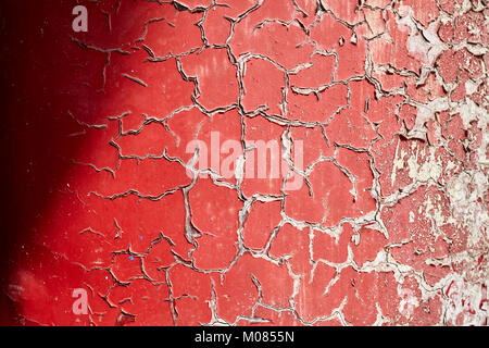 Cracking and peeling paint on a wall, background or texture, selective focus. Stock Photo