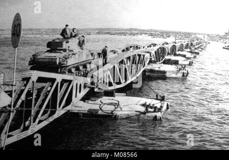 D Day - Mulberry Harbour defences with a Sherman tank  seen landing during WWII Stock Photo