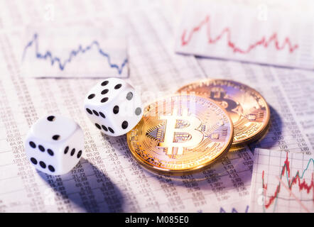 Two coins of crypto-currency Bitcoin with two dice Stock Photo