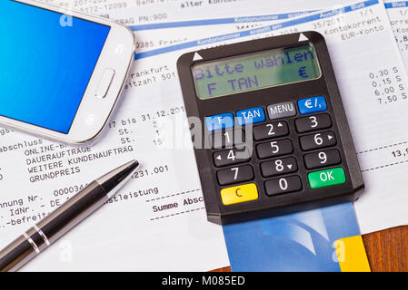 Tan generator with check card and statement of bank account Stock Photo