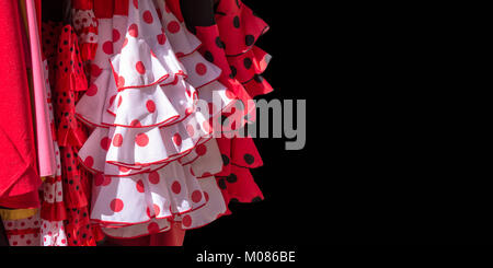 Red flamenco dresses on black background in Seville, Andalusia, Spain Stock Photo