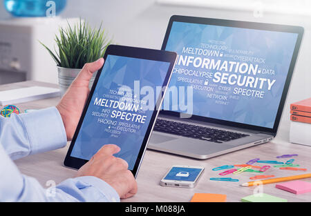 Information security concept on digital tablet pc in male hands and laptop screen Stock Photo