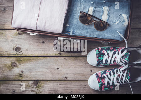 Open suitcase with casual female clothes Stock Photo