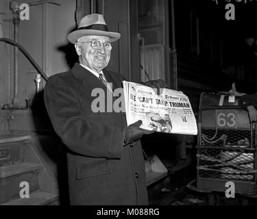 Former President Harry S. Truman by a train holding a copy of the Chicago Daily Tribune with headline 'Ike Can't Take Truman'  Friday November 20, 1959. Stock Photo