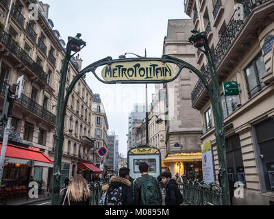 PARIS, FRANCE - DECEMBER 20, 2017: Paris Metro Station in Chatelet with a typical art deco Metro sign designed by Guimard combined to a street lamp. P Stock Photo