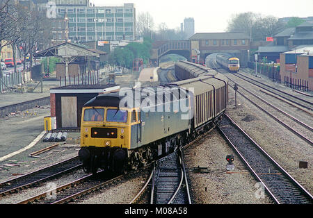 A class 47 diesel locomotive number 47299 heads onto the Greenford branch with a rake of ferry vans at West Ealing. 10th April 1991.