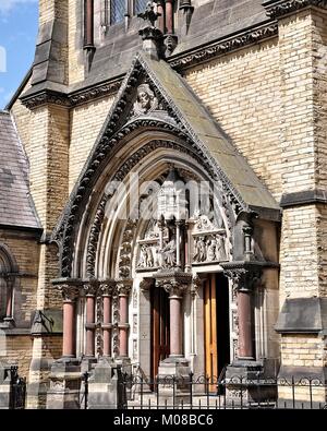 Entrance to a church with ornate cavings above the doorway. Stock Photo