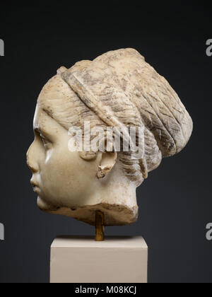 The marble portrait of a young woman displays detailed realism and classical sculptural skill, reflecting artistic traditions of its period. Stock Photo