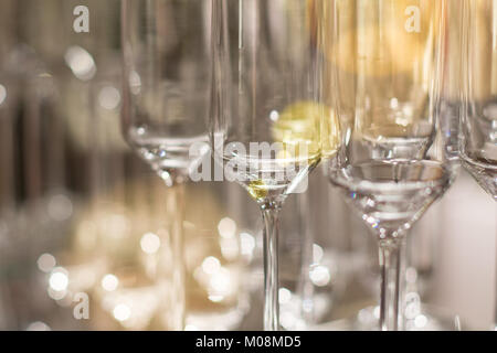 Elegant luxury shiny wine glasses lined up in rows on bar table background image Stock Photo