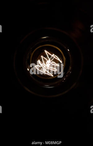 A classic Edison light bulb on black background Stock Photo