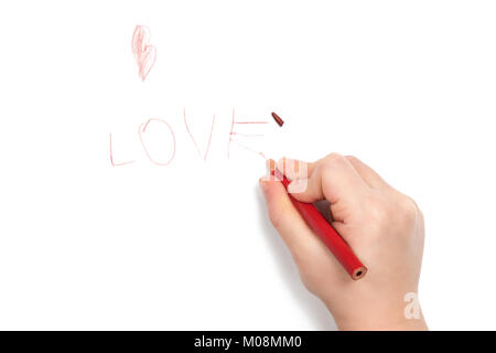 Child hand wrote the word love and broke the lead on the last letter, isolated on white background Stock Photo