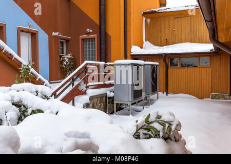 Two residential heat pumps buried in snow Stock Photo