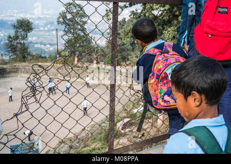 Local boys looking obn the football in the Changunarayan, Nepal, Asia Stock Photo
