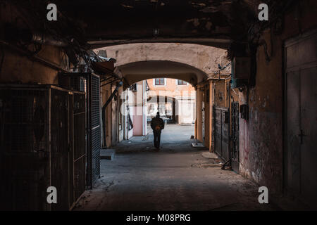 Man walking alone through old passage in Odessa,Ukraine. Stock Photo