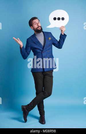 Full length portrait of man with speech bubble posing Stock Photo