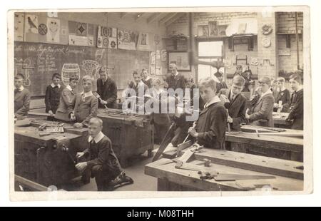 Original early 1900's Edwardian postcard of Edwardian schoolboys in woodwork carpentry class carpentry, Class 362, carving lesson, circa 1910, probably Yorkshire, England U.K. Stock Photo
