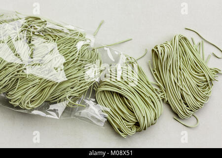 Directly above of raw green tagliatelle in a plastic bag Stock Photo