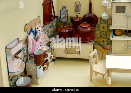 Grandmother's Old Dolls Kitchen with accessories. Toys for girls from the 40s or 50s. Stock Photo