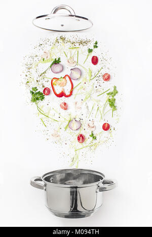 Assorted fresh vegetables falling into a bowl, on white background Stock Photo
