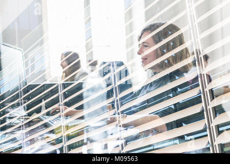 Yound devoted female software developers team working on desktop computer in IT statup company. Stock Photo