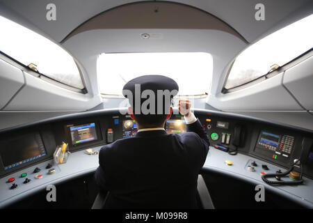 Guiyang. 18th Jan, 2018. A driver works on board a bullet train for test operation on Chongqing-Guiyang railway, Jan. 18, 2018. A railway connecting Chongqing and Guiyang, two major cities in southwest China, will open Jan. 25. With a total length of 347 kilometers, the railway will have 12 stops. Designed for passenger trains running at a speed of 200 km per hour, the railway will improve traffic between China's southwest and the rest of the country. Credit: Wu Jibin/Xinhua/Alamy Live News Stock Photo