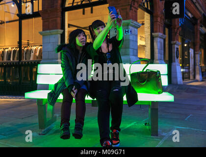 London, UK. 19th Jan, 2018. Two visitors take selfies on Bernd Spiecker's Lightbench installation. Lumiere London is a lights festival that presents an array of public art work and light installations across the capital. Credit: Imageplotter News and Sports/17�Թ����� Live News Stock Photo
