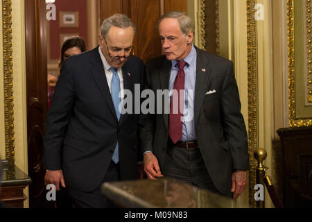 United States Senate Minority Leader Charles Schumer (Democrat of New York) left, and US Senator Tom Carper (Democrat of Delaware) exit a Democratic Caucus meeting shortly before a scheduled vote on a night when Congress tries to pass a spending bill to avoid a government shutdown in Washington, DC on January 19th, 2018. Credit: Alex Edelman/CNP /MediaPunch Stock Photo