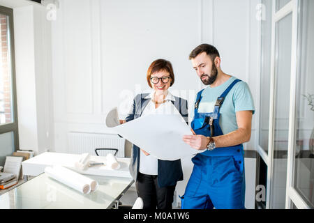 Repairman with senior architect or client at the office Stock Photo