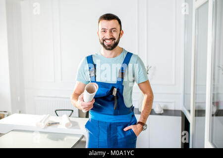Repairman with paper drawings at the office Stock Photo