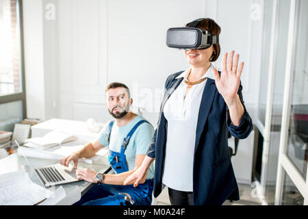 Senior woman using vr glasses to imagine or design a project Stock Photo