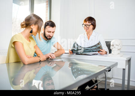 Young couple having a consultation with senior doctor Stock Photo