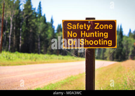 A Safety Zone, No Hunting or Shooting sign Stock Photo