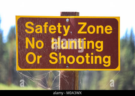 A Safety Zone, No Hunting or Shooting sign Stock Photo