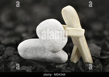 Male is stacking white pebbles on each other Stock Photo