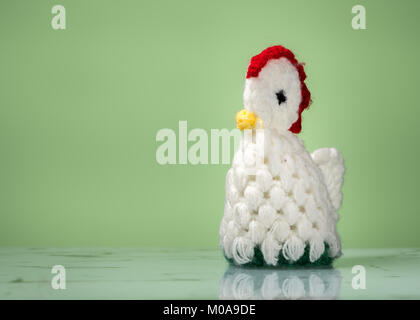 Closeup of an egg cozy, knitted white chicken Stock Photo