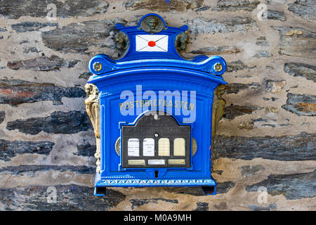 German old blue post box hanging on a brick wall Stock Photo