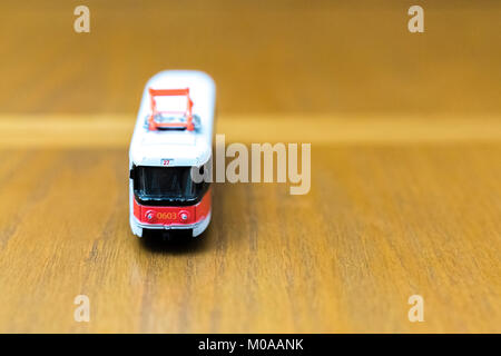 old toy tram on a wooden background Stock Photo
