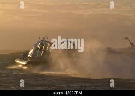 The amphibious Hovertravel hovercraft departing Southsea Hoverport, carrying passengers across the Solent at sunset to Ryde on the Isle of Wight Stock Photo