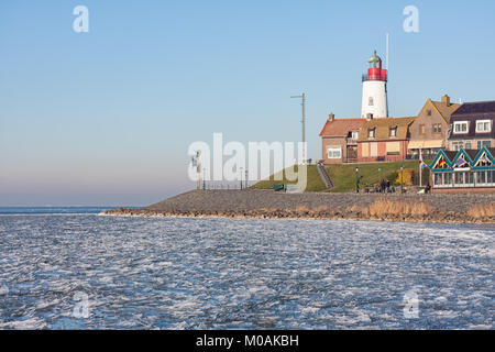 Skyline Dutch fishing village Urk in winter with frozen sea Stock Photo