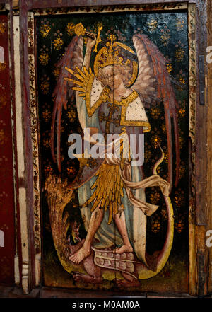 St Michael the Archangel with shield & sword slaying a seven-headed dragon (he has severed 2 heads) on the S parclose of Ranworth church, Norfolk, UK. Stock Photo