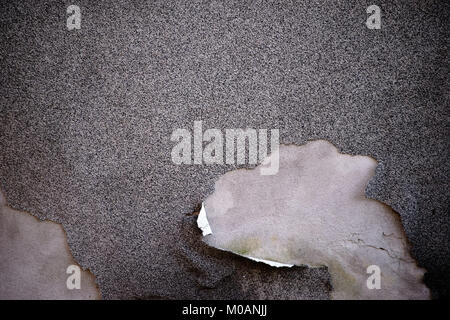 The close up of a facade with a chipped plaster layer. Stock Photo
